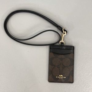 COACH badge lanyard in brown & black. 2 card slots and a see through badge slot